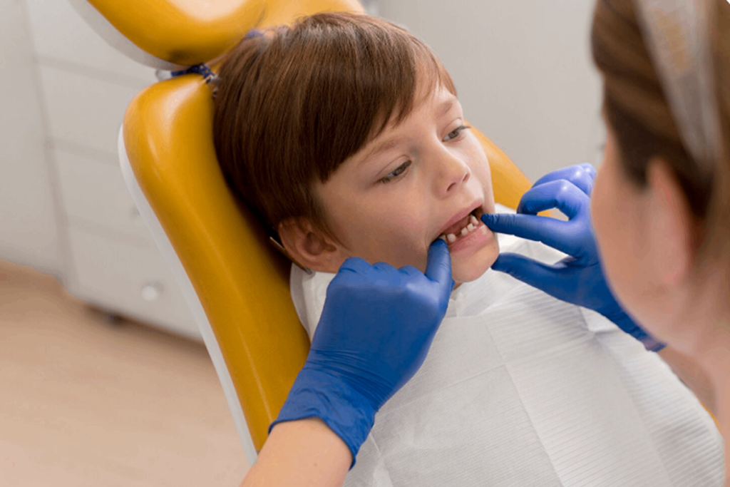 Pediatric airway dentist checking a child’s jaw.